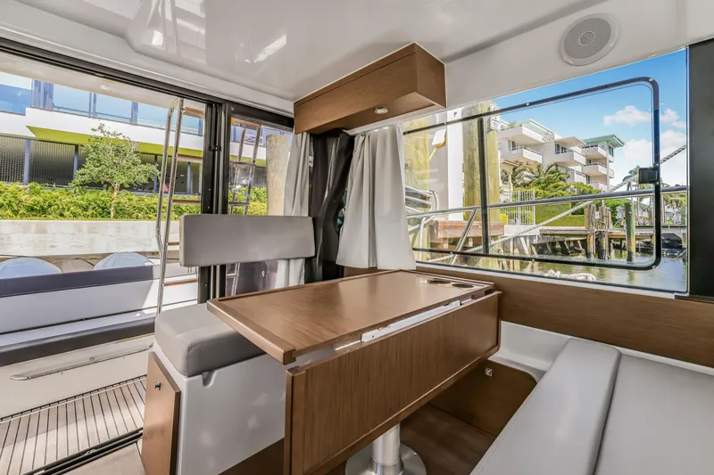 Slide: The Image of Interior of 2024 Jeanneau NC1095 Fly yacht with modern seating and large windows. - 18