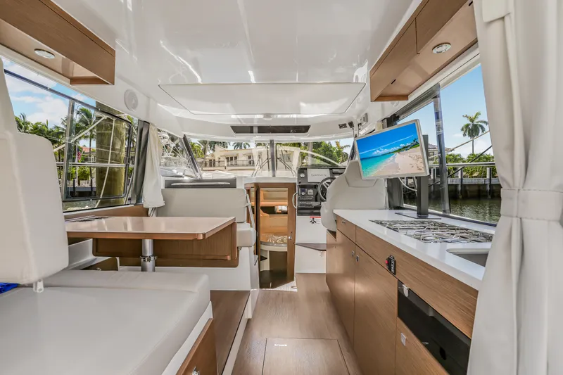 Slide: The Image of Interior of 2024 Jeanneau NC1095 Fly yacht with modern kitchen and seating area. - 19