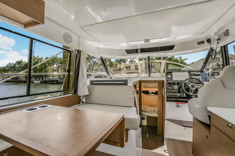 Slide: The Image of Interior of 2024 Jeanneau NC1095 Fly yacht, featuring modern helm and seating area. - 20