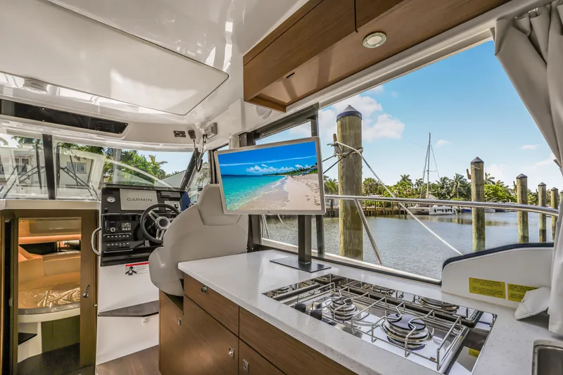 Slide: The Image of Interior of 2024 Jeanneau NC1095 Fly yacht with modern kitchen and scenic marina view. - 21