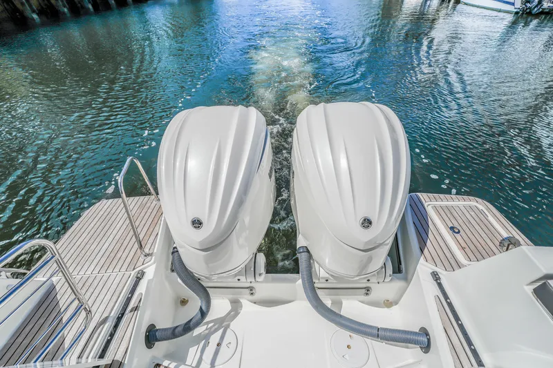 Slide: The Image of 2024 Jeanneau NC1095 Fly with dual outboard motors on water. - 23