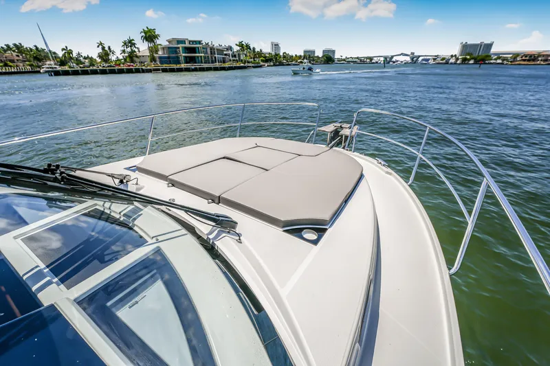 Slide: The Image of 2024 Jeanneau NC1095 Fly yacht cruising on a sunny day, featuring a spacious deck. - 26