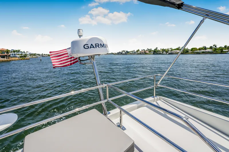 Slide: The Image of 2024 Jeanneau NC1095 Fly boat with Garmin radar and American flag on water. - 29