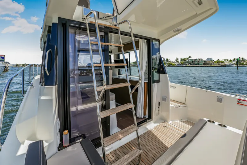 Slide: The Image of 2024 Jeanneau NC1095 Fly yacht with flybridge, docked on a sunny day. - 30