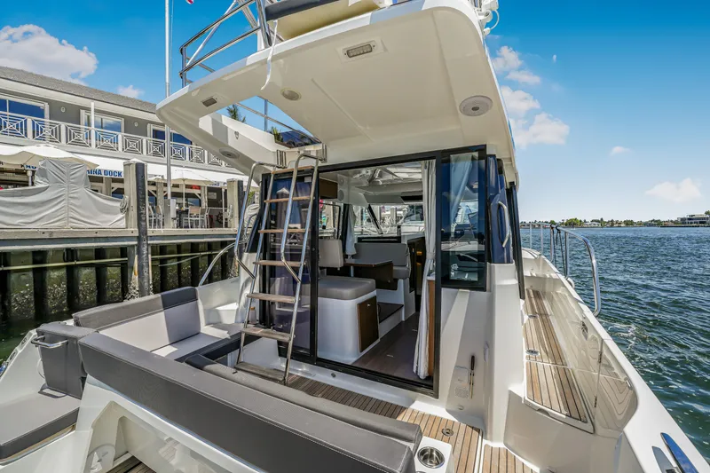 Slide: The Image of 2024 Jeanneau NC1095 Fly yacht with open deck and marina view. - 31