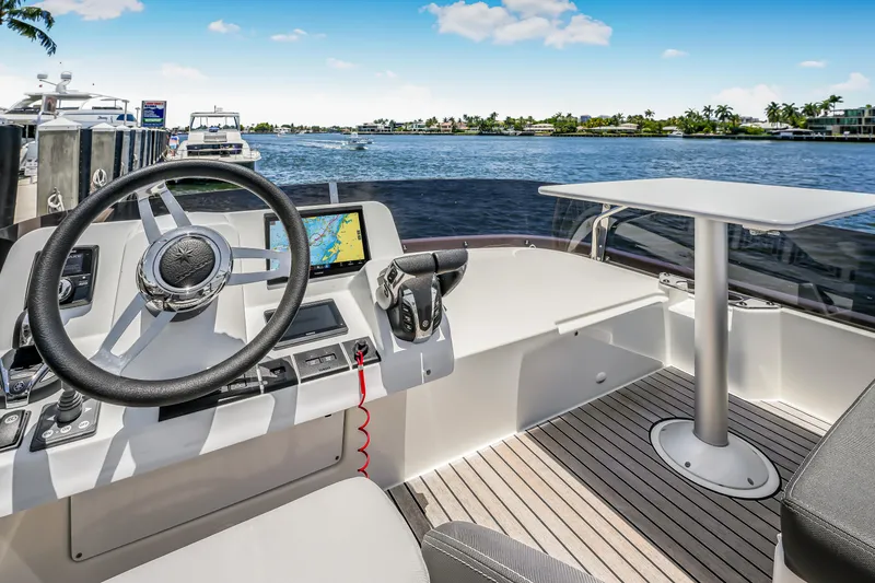 Slide: The Image of 2024 Jeanneau NC1095 Fly boat helm with steering wheel and navigation system. - 32