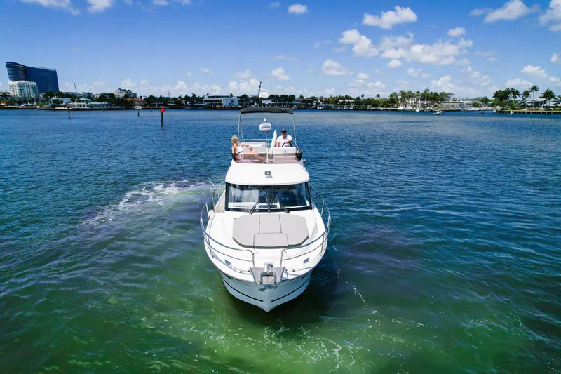 Slide: The Image of 2024 Jeanneau NC1095 Fly cruising on a sunny day, with passengers enjoying the view. - 7