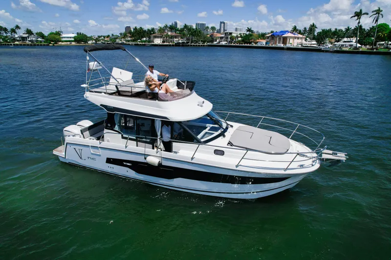 Slide: The Image of 2024 Jeanneau NC1095 Fly yacht cruising on a sunny day with passengers relaxing. - 8