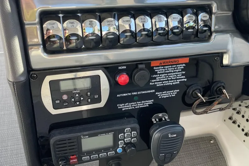 Slide: The Image of Control panel of a 2020 Formula 310 Bowrider boat with switches and warning labels. - 13