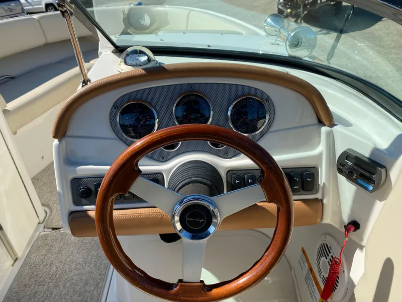 Slide: The Image of 2008 Chris-Craft Launch 22 Heritage Edition dashboard with wooden steering wheel and gauges. - 20