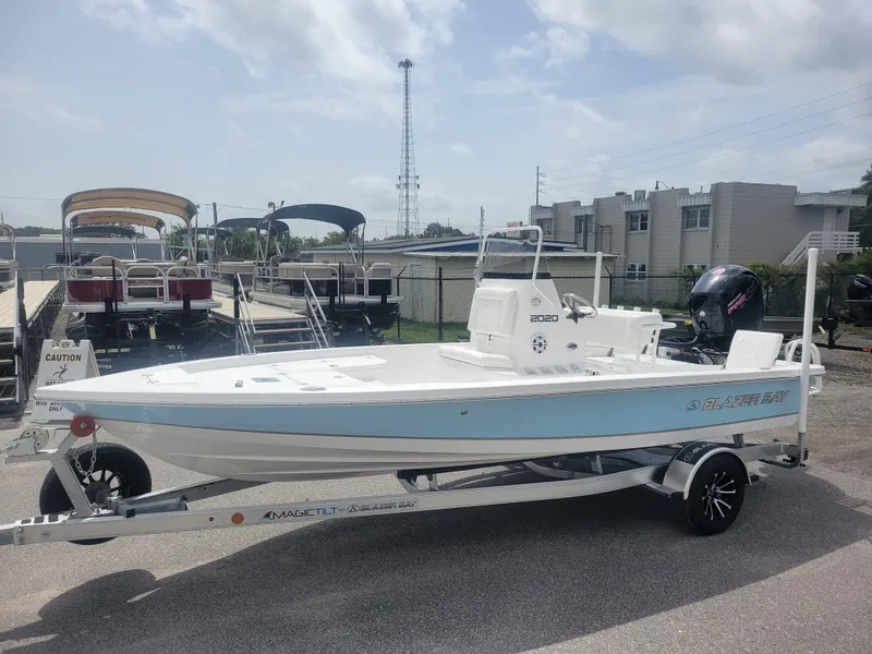 The Image of 2025 Blazer Bay 2020 boat on trailer, parked outdoors under cloudy sky. - 1