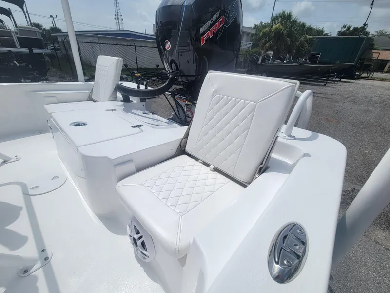 Slide: The Image of 2025 Blazer Bay boat with white seating and Mercury engine in a sunny outdoor setting. - 12