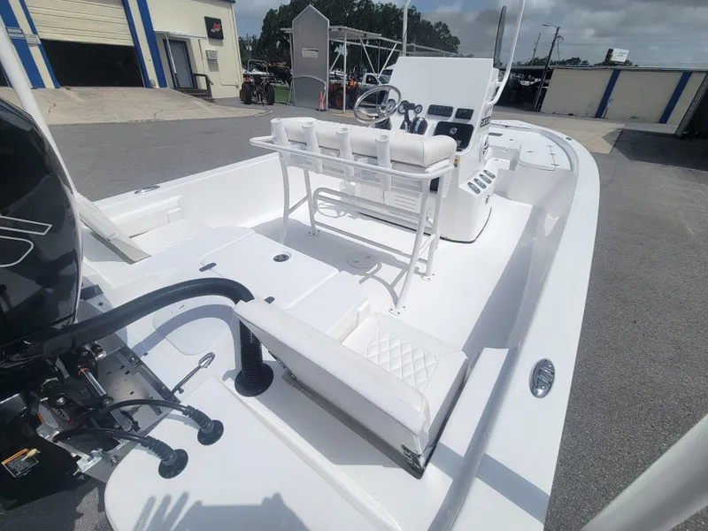 Slide: The Image of 2025 Blazer Bay boat with white interior and modern console, parked outdoors. - 13