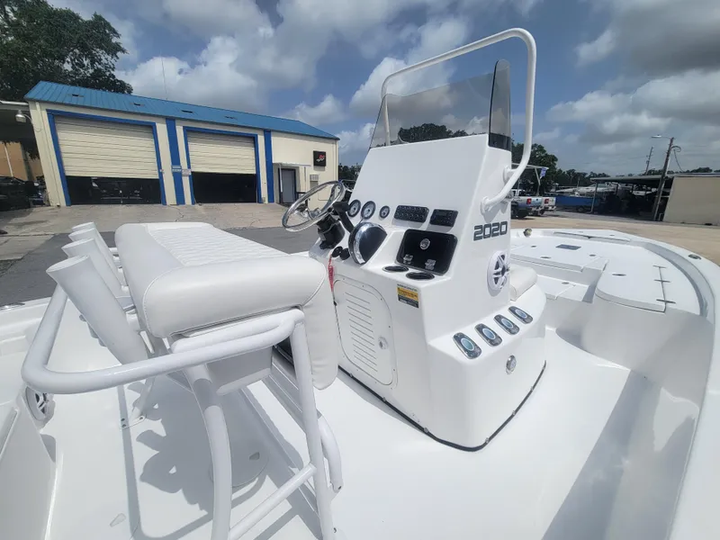 Slide: The Image of 2025 Blazer Bay 2020 boat with white console and seating, parked outdoors. - 14