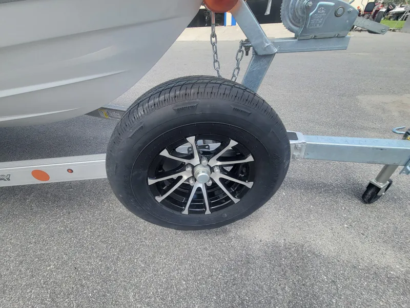 Slide: The Image of Trailer wheel of a 2025 Blazer Bay 2020 on asphalt surface. - 20