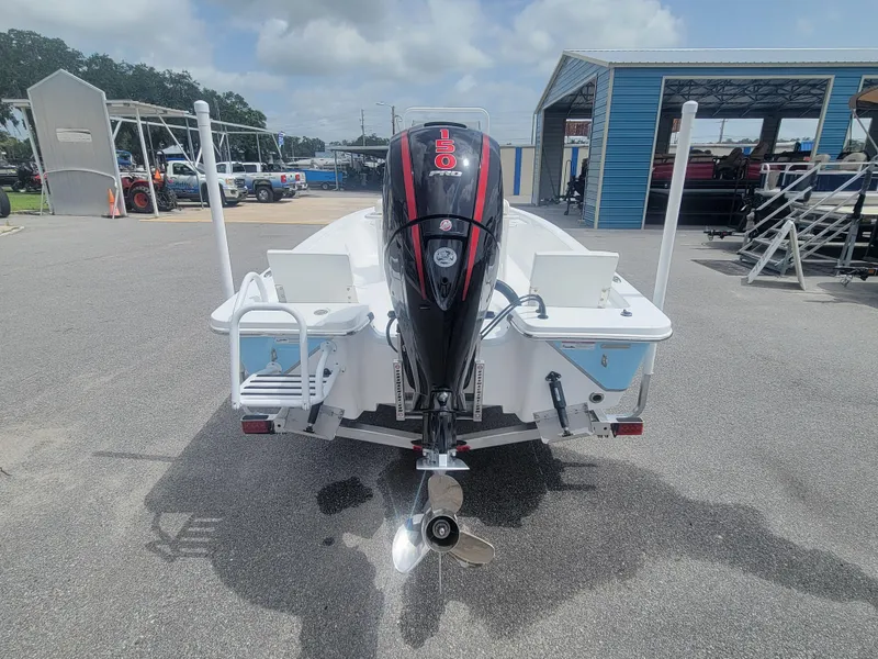 Slide: The Image of 2025 Blazer Bay 2020 boat with outboard motor, parked on a sunny day. - 5