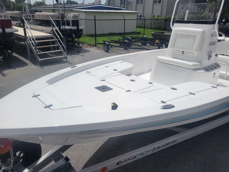 Slide: The Image of 2025 Blazer Bay 2020 boat on trailer, parked outdoors in a sunny setting. - 7