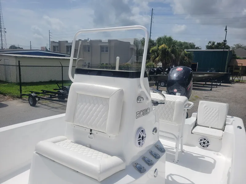 Slide: The Image of 2025 Blazer Bay 2020 boat with white seating and console, parked outdoors. - 8