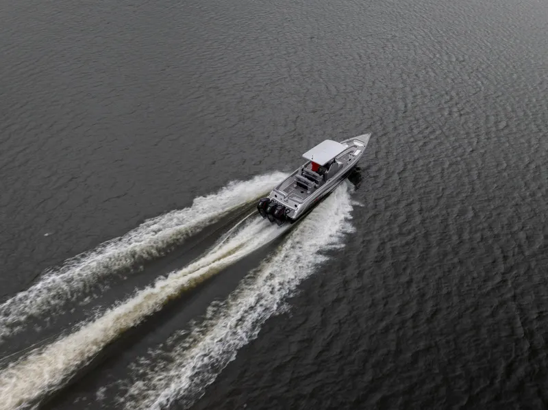 Slide: The Image of 2025 Donzi 39 VRZ speedboat cruising on open water, aerial view. - 12