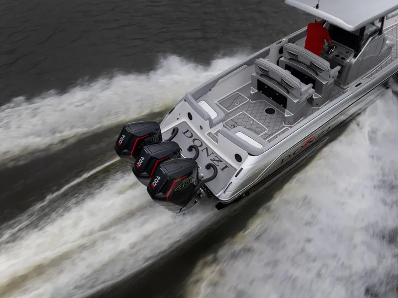 Slide: The Image of 2025 Donzi 39 VRZ boat with triple outboard engines cruising on water. - 14