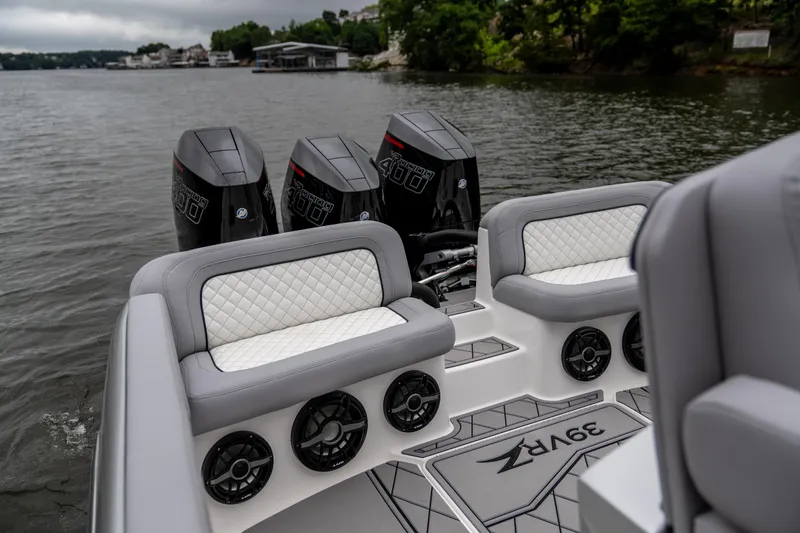 Slide: The Image of 2025 Donzi 39 VRZ boat interior with quad engines on a calm lake. - 15