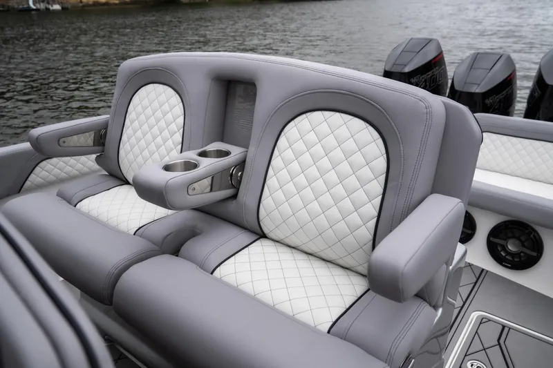 Slide: The Image of Luxury seating on 2025 Donzi 39 VRZ boat with quilted upholstery and cup holders. - 24