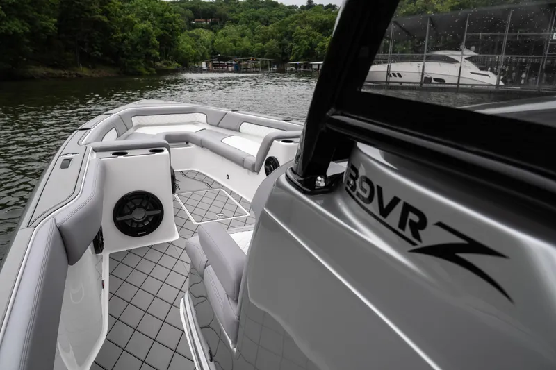 Slide: The Image of 2025 Donzi 39 VRZ boat interior with sleek seating and modern design on a scenic lake. - 26