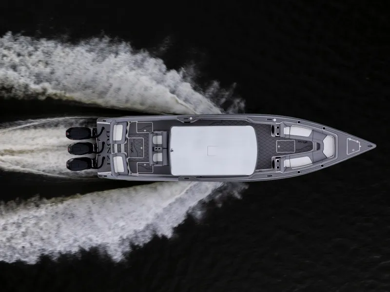 Slide: The Image of Overhead view of 2025 Donzi 39 VRZ speedboat on water, creating dynamic wake patterns. - 4