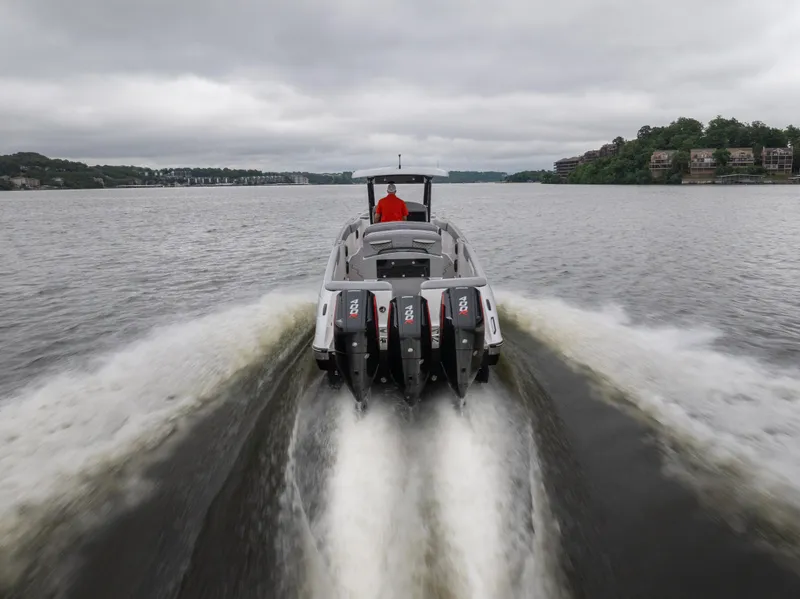 Slide: The Image of 2025 Donzi 39 VRZ speedboat cruising on a lake with powerful engines. - 6
