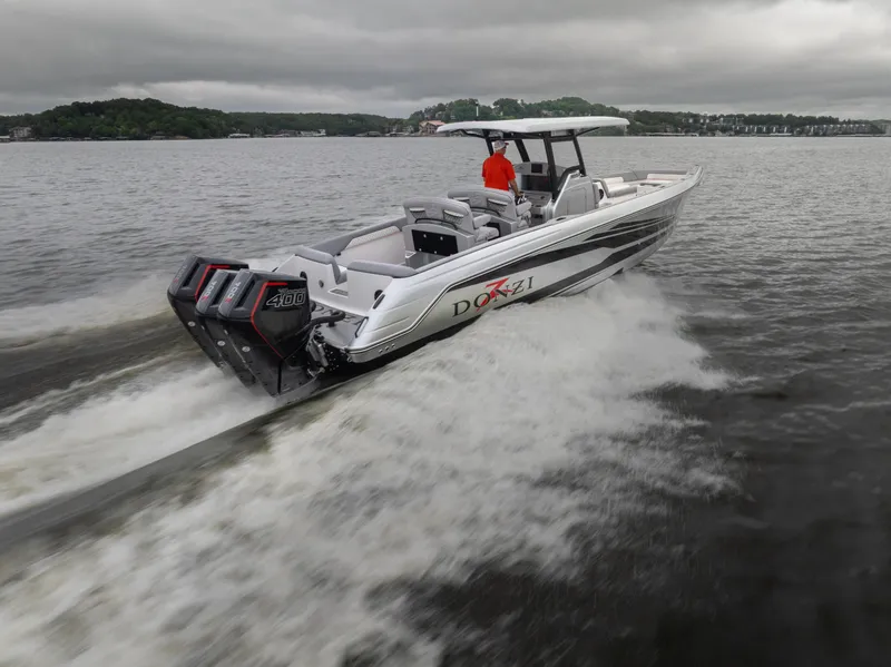 Slide: The Image of 2025 Donzi 39 VRZ speedboat cruising on a lake with powerful engines. - 8