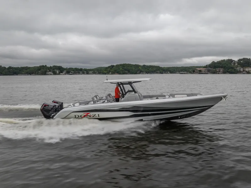 Slide: The Image of 2025 Donzi 39 VRZ speedboat cruising on a lake under cloudy skies. - 9