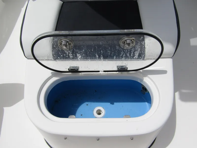 Slide: The Image of Livewell on 2021 Tidewater 2700 Carolina Bay boat, open lid, blue interior. - 19