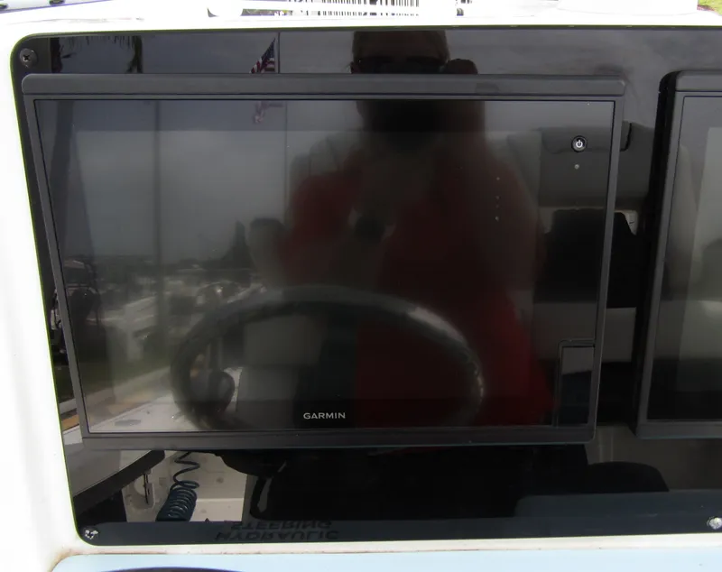 Slide: The Image of Garmin display on 2021 Tidewater 2700 Carolina Bay boat dashboard. - 25
