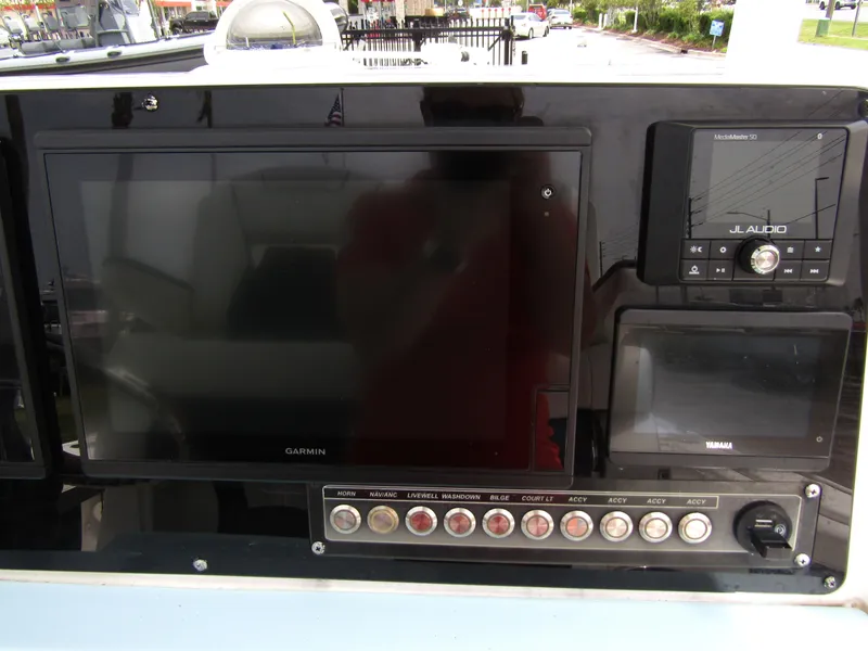 Slide: The Image of Dashboard of 2021 Tidewater 2700 Carolina Bay with Garmin and JL Audio systems. - 26