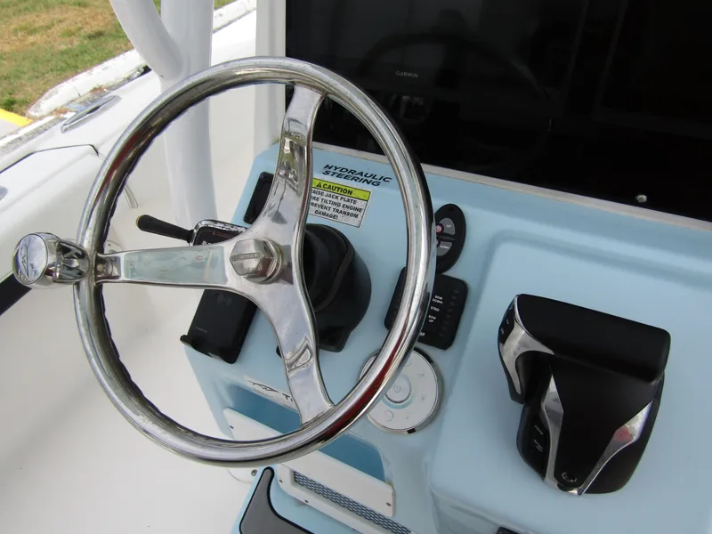 Slide: The Image of Steering wheel and controls of 2021 Tidewater 2700 Carolina Bay boat. - 28