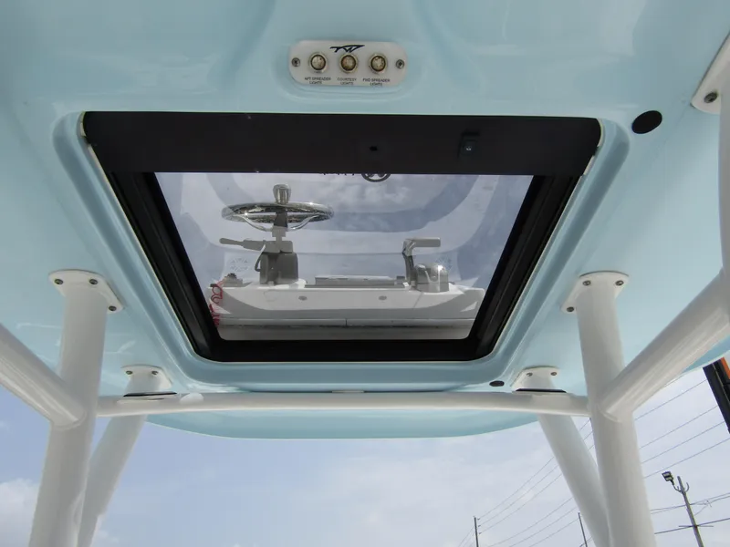Slide: The Image of 2021 Tidewater 2700 Carolina Bay boat roof view with steering wheel visible through skylight. - 31