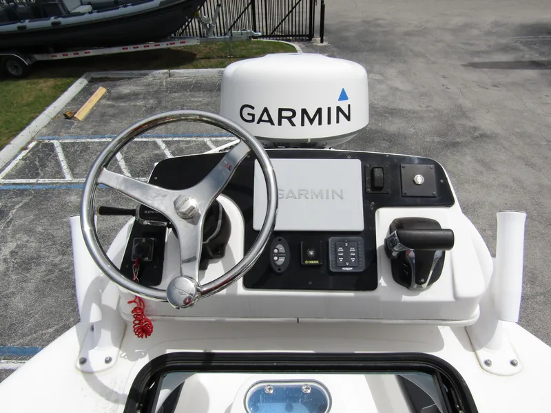 Slide: The Image of 2021 Tidewater 2700 Carolina Bay helm with Garmin navigation system and steering wheel. - 33