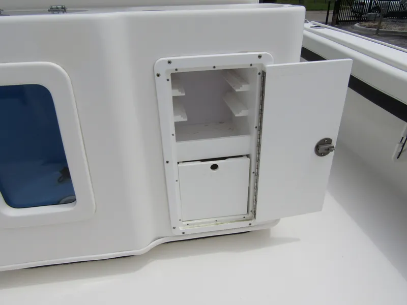 Slide: The Image of 2021 Tidewater 2700 Carolina Bay boat storage compartment with open door. - 42