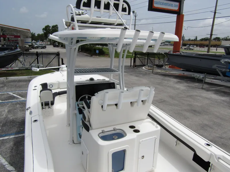 Slide: The Image of 2021 Tidewater 2700 Carolina Bay boat with center console and T-top in a parking lot. - 45