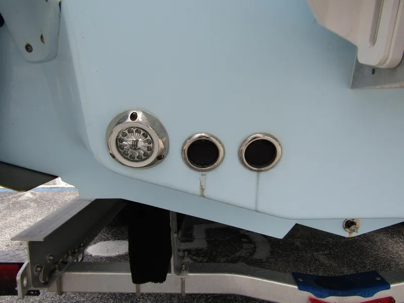 Slide: The Image of 2021 Tidewater 2700 Carolina Bay boat stern with trailer, featuring exhaust ports and light. - 9