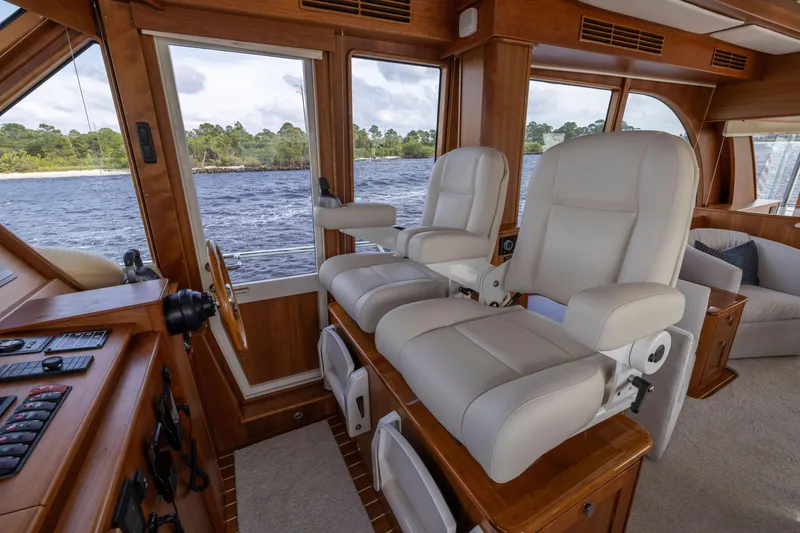 Slide: The Image of Interior of 2026 Sabre 58 Salon Express yacht with luxurious seating and scenic water view. - 12
