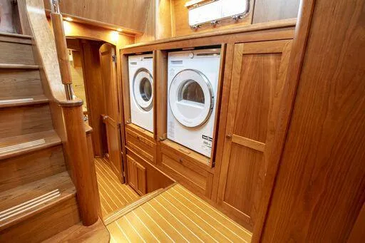 Slide: The Image of Laundry area in 2026 Sabre 58 Salon Express yacht with wooden interior. - 16