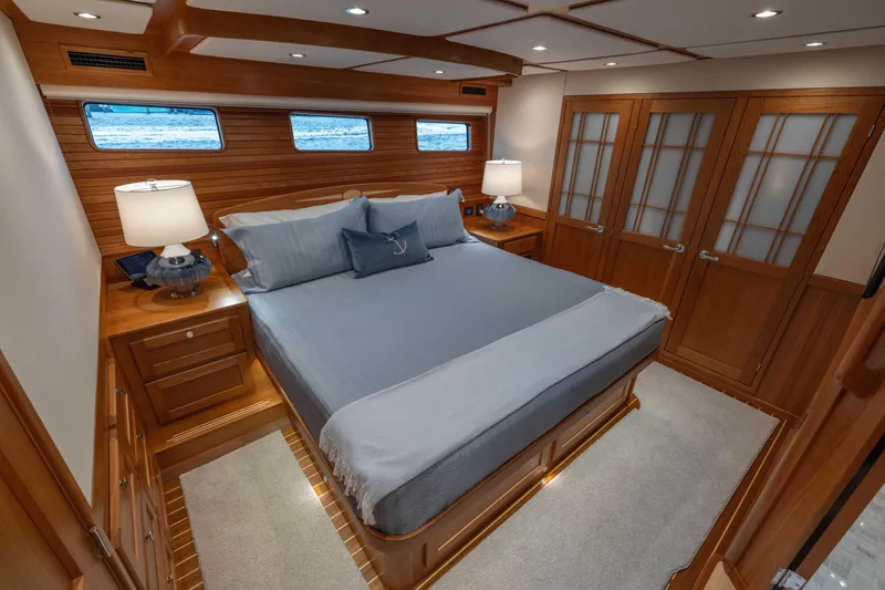 Slide: The Image of Luxurious bedroom interior of 2026 Sabre 58 Salon Express yacht with wood paneling and elegant bedding. - 17