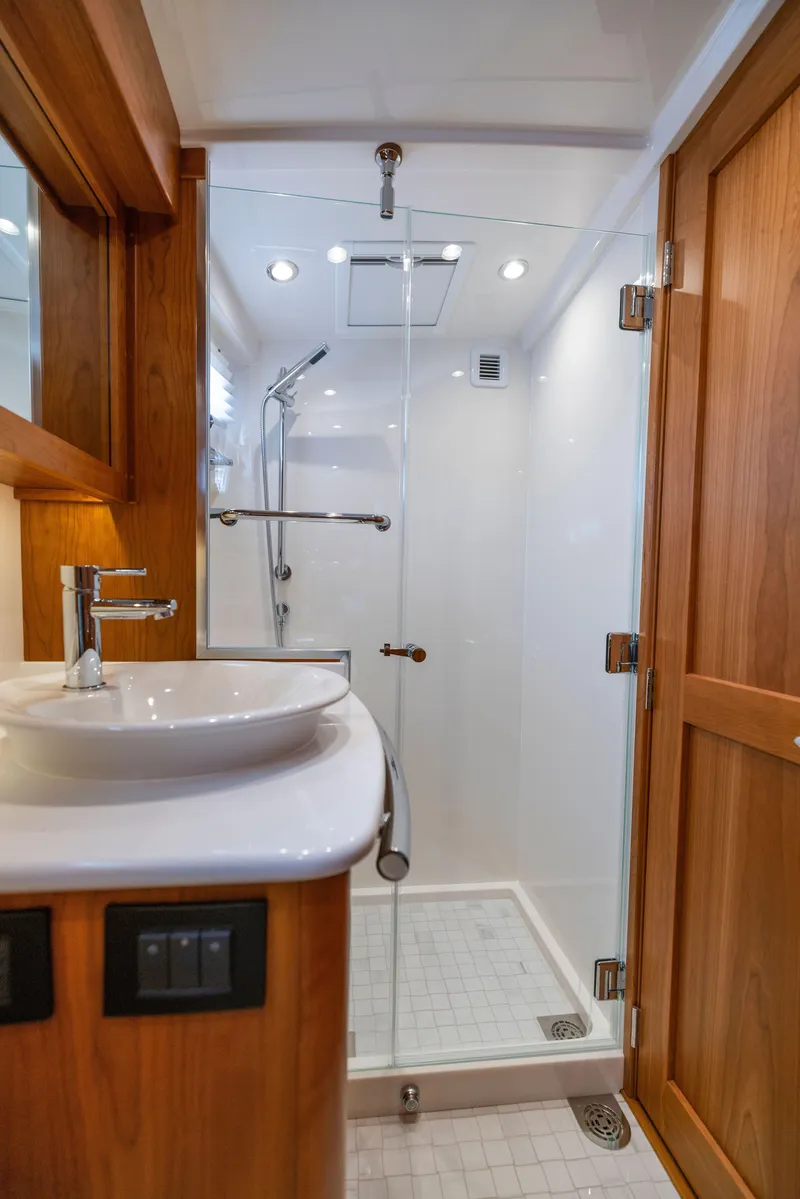 Slide: The Image of Luxurious bathroom in 2026 Sabre 58 Salon Express yacht with modern shower and wooden accents. - 21