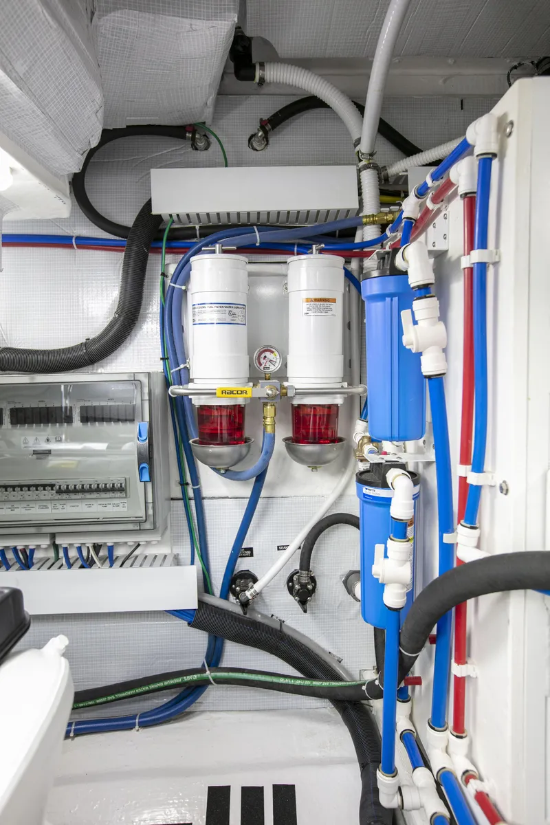 Slide: The Image of Engine room of 2026 Sabre 58 Salon Express, showcasing advanced filtration and piping systems. - 27