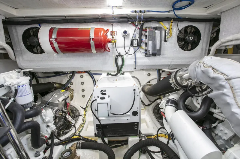 Slide: The Image of Engine room of 2026 Sabre 58 Salon Express with fire extinguisher and mechanical components. - 29