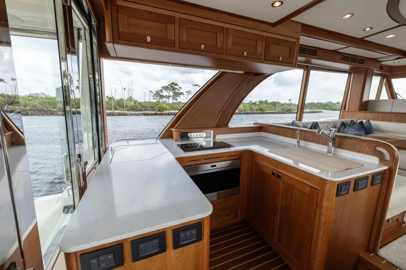 Slide: The Image of Luxurious interior of 2026 Sabre 58 Salon Express yacht with modern kitchen and scenic view. - 3