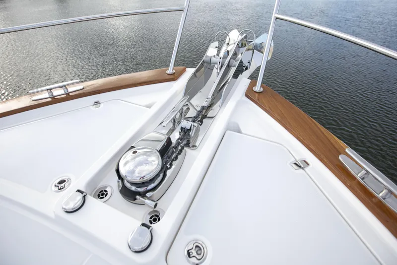 Slide: The Image of Bow of 2026 Sabre 58 Salon Express yacht with anchor system, on calm water. - 33