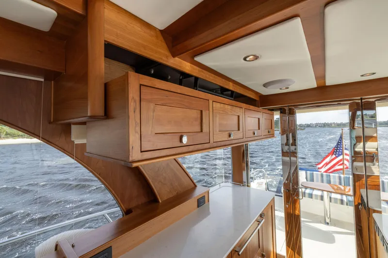 Slide: The Image of Interior of 2026 Sabre 58 Salon Express yacht with wooden cabinetry and water view. - 5