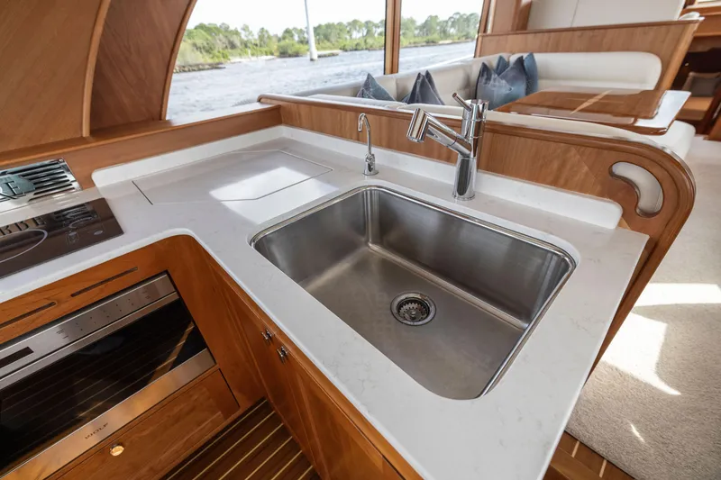 Slide: The Image of Modern kitchen area in 2026 Sabre 58 Salon Express yacht with stainless steel sink. - 7